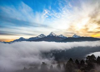 snow covered mountain under cloudy sky during daytime